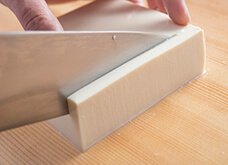 豆腐を横向きに置き、端から均等に、1～1.5mm幅で切り、まな板に倒す。