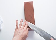 【裏面】研ぎ石は約30分水に浸し、十分水を含ませておく。気泡が出なくなるまでが目安。刃先を外に向け、45度の角度で研ぎ石に置く。
